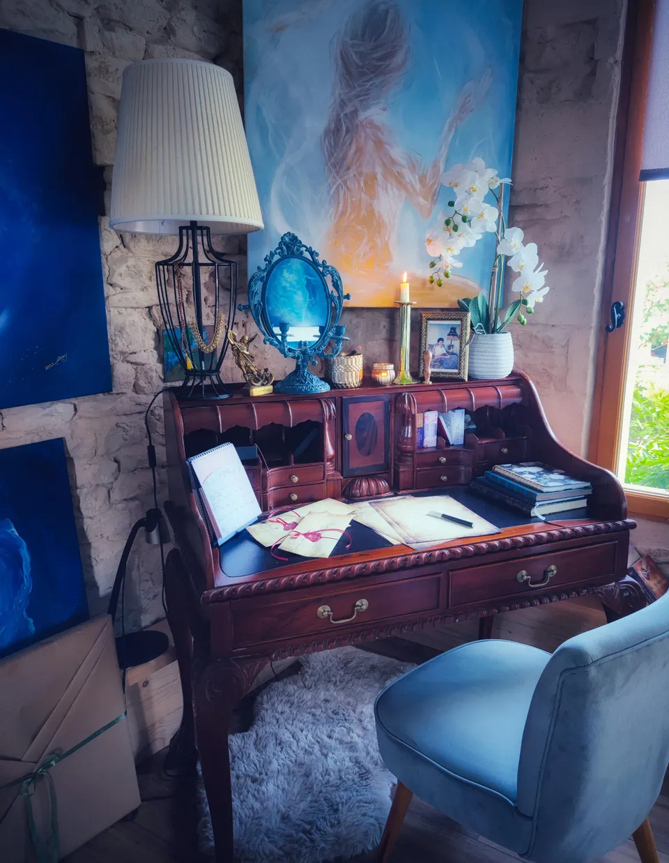 The artist’s writing desk, among stone and old furniture